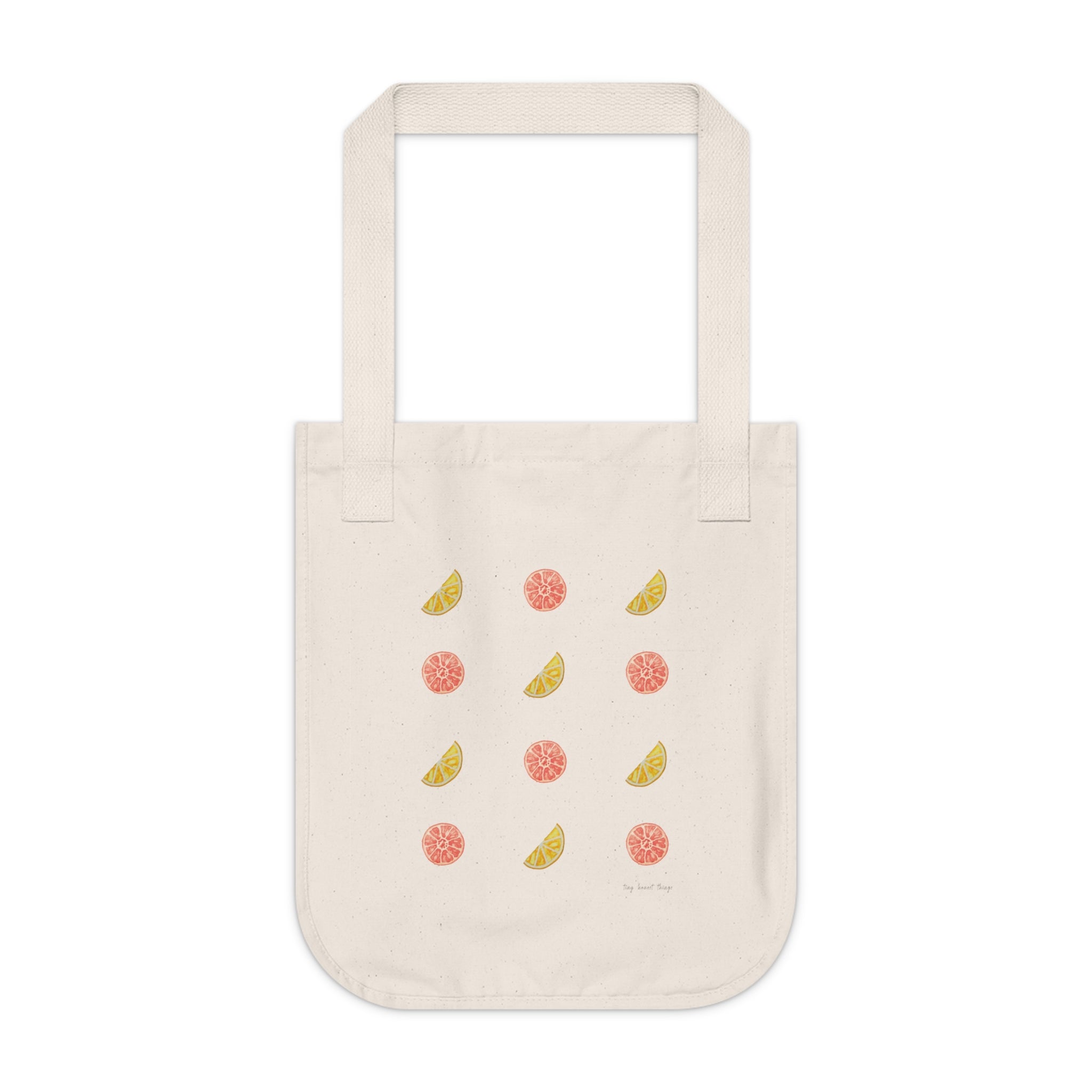 Beige tote bag with fruit patterns on a white background